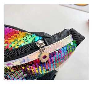 Macro detail of rainbow sequins and flower zipper pull on a girls seashell handbag
