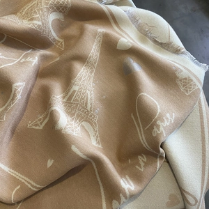 Beige cashmere-like scarf featuring Eiffel Tower Paris patterns and soft tassel edges