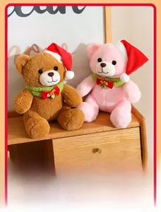 Close-up of Christmas teddy bears in red hats and green scarves with golden bells