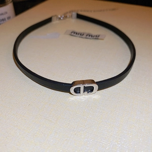 Minimalist black faux leather choker necklace featuring a silver interlocking CD metal charm