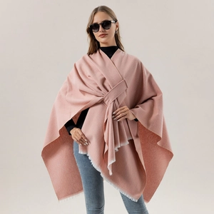 Detailed view of pink cashmere-like shawl with white fringe accents and front knot style