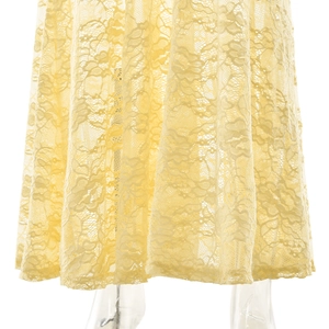 Detail of yellow lace fabric texture and ruffle hem on a sexy bodycon summer dress