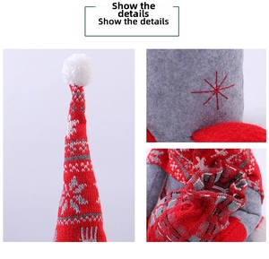 Gros plan sur la poupée de Noël tricotée rouge et grise avec broderies flocons de neige
