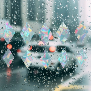 Rainbow prism diamond window film with holographic laser effect on rainy glass surface