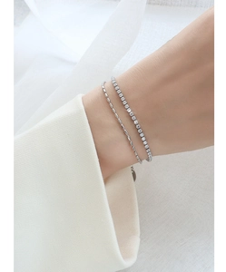 Detail view of double-layer titanium steel bracelet featuring a zircon tennis chain