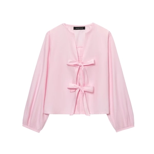 Pink long sleeve V-neck blouse with two large decorative bows and lantern sleeve cuffs