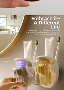 Magnetic toothbrush holder showing wall-mounted striped cups with drainage feature