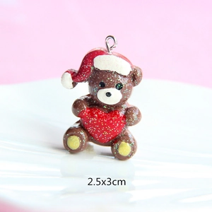 Macro view of a 2.5x3cm brown resin Christmas bear pendant with a red heart and glitter