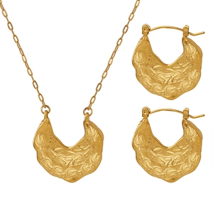 Golden jewelry set featuring hammered lava texture necklace and crescent earrings