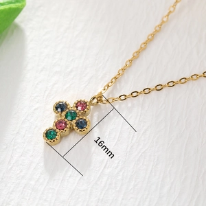Detailed macro view of 16mm gold-plated cross pendant with vibrant multi-color gemstones