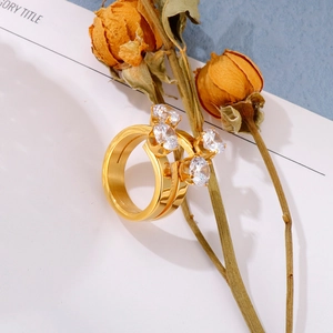 Detailed view of 18K gold-plated double-band ring with four round-cut clear gemstones