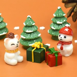 Macro view of Christmas miniature resin figurines with snowman bear and gift boxes