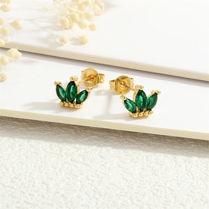 Macro shot of 18K gold plated clover studs with emerald green marquise cut zircons