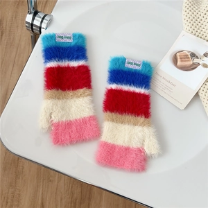 Detail of colorful striped knitted fingerless gloves with soft plush inner lining