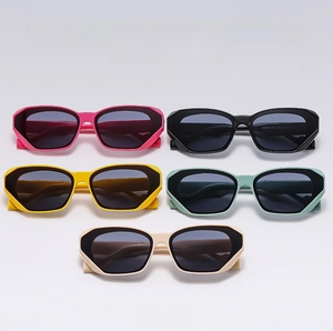 Flat lay of colorful hexagonal cat eye sunglasses in pink black yellow mint and beige