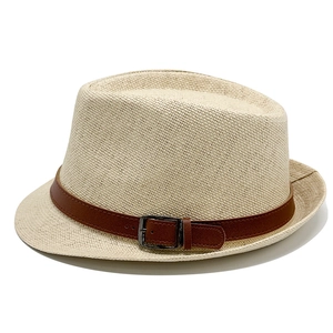 Detailed straw weave texture on beige fedora hat with a brown faux leather belt buckle