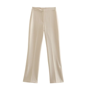 Close-up of beige high-waist flared trousers with front crease seam and minimalist suit fabric