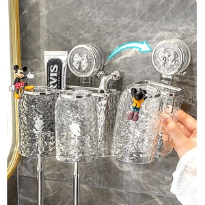 Modern wall-mounted 3-cup toothbrush holder with silver base and bow detail