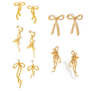 Elegant 18K gold plated bow earrings with tassels and zircon stones on white background