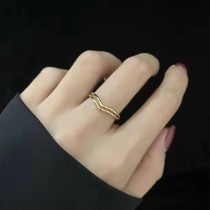 Close-up of double V-shaped 18K gold plated stainless steel ring on female hand