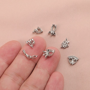 Handheld silver DIY jewelry settings with heart and grape designs in stainless steel