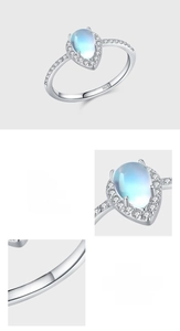 Macro detail of pear-cut moonstone ring with pave setting and S925 hallmark on silver band