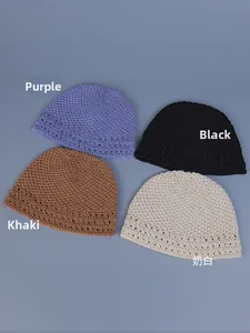 Flat lay of handmade crochet beanies in purple, black, khaki, and cream white colors
