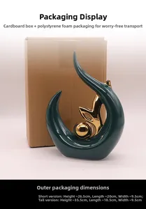 Ceramic art sculpture detail showing emerald green glaze and golden sphere with packaging box