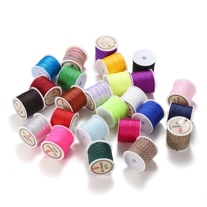 Detailed close-up of colorful 0.8mm polyester cords on spools for DIY jewelry making