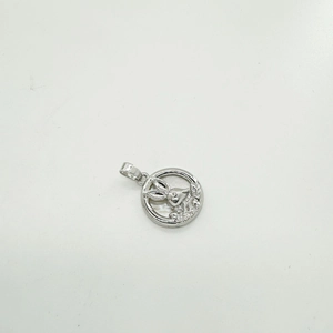 Macro shot of silver circular pendant with stylized deer and leaf engraving