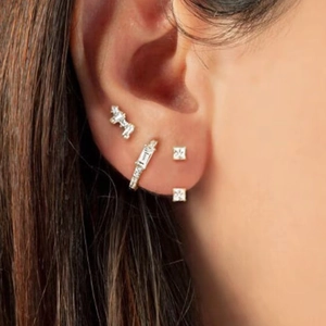 Detailed view of 925 silver earring set with zircons worn on ear for minimalist style