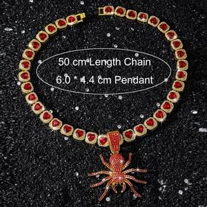 Macro detail of gold spider pendant with red crystals and 50cm heart shaped link chain