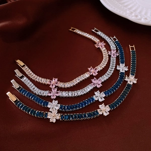Macro shot of baguette-cut zircon flower bracelets on luxury velvet background