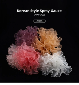 Detail of multi-colored spray gauze with wavy pleated edges for floral packaging