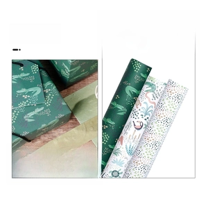 Detailed view of jungle animal gift wrapping paper featuring cute crocodiles and hornbills
