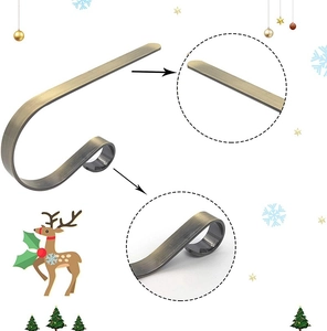 Detailed view of brushed bronze metal fireplace hook with magnified texture and structure