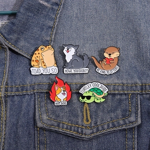 Set of 5 cartoon animal enamel pins featuring a turtle and frog on denim jacket