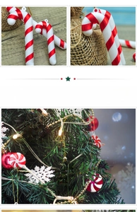 Detail of red and white candy cane and peppermint ornaments hanging on a Christmas tree