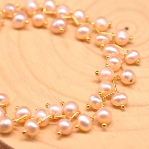 Elegant multi-layer set of light pink freshwater pearls with golden metal chain links
