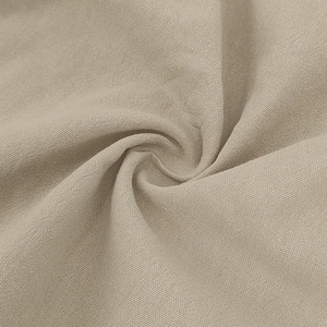 Close-up of breathable beige cotton linen fabric texture for men's casual polo shirts