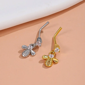 Detailansicht der bienenförmigen Bauchnabelstecker mit Zirkonia-Inlay in Gold und Silber