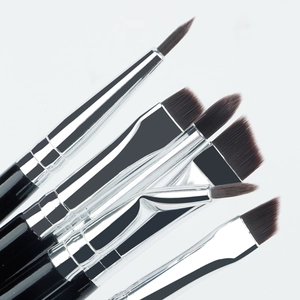 Macro detail of professional eye makeup brushes with black handles and silver ferrules