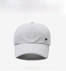Front detail of white quick-dry baseball cap featuring laser-cut ventilation holes