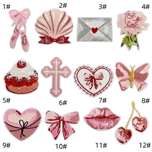Collection of 12 assorted embroidered patches including ballet shoes and floral motifs