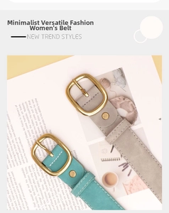 Detail of grey and green suede leather belts with golden oval metal buckles on a magazine