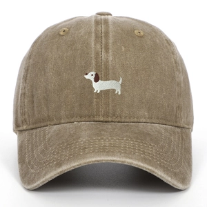 Detailed close-up of a white dachshund embroidery on a tan washed cotton baseball cap