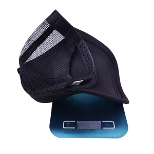 Weight measurement of black mesh trucker hat showing approximately 59 grams on digital scale