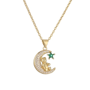 Gold moon and bear pendant necklace with sparkling white zircons and a green star gem