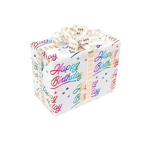 Detail of white birthday gift box with rainbow lettering and decorative white ribbon