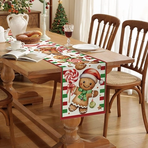 Christmas table runner with gingerbread and candy patterns on wooden dining table